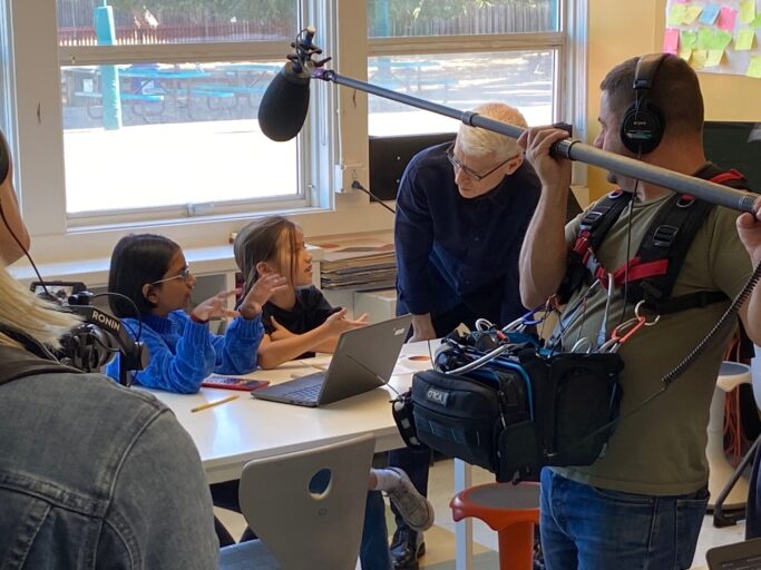 Anderson Cooper of 60 Minutes speaks to two students in a classroom of Khan Lab School while they are being filmed.